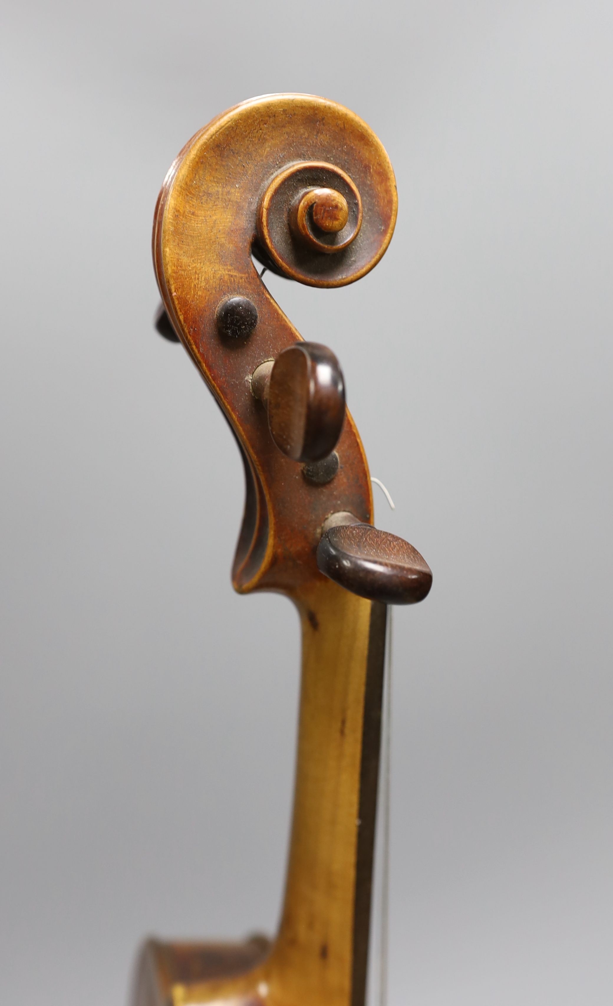 A 19th century violin with 14 inch 2 piece back, unlabelled, cased with silver mounted bow.